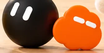 Grok Bot, a black ball character with two white eyes next to a small orange cloud character